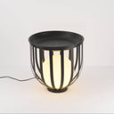 Close-up view of indoor floor lamp and matte metal top.