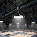 Outway high bay LED  light hanging from steel beam in a large indoor sports arena, illuminating multiple basketball courts below with bright white light.