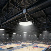 Outway high bay LED  light hanging from steel beam in a large indoor sports arena, illuminating multiple basketball courts below with bright white light.
