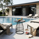Outdoor pool area with lounge chairs, a table, and poolside activities.