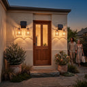 Dual-head solar wall sconce flanking wooden front door at dusk — symmetrical installation enhances curb appeal, with UV-resistant rattan shades and anti-rust bracket built for Australian outdoor conditions.