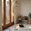 Floor lamp with pleated shade in a room with a cat sitting on the floor.