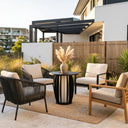 Outdoor patio setting with chairs, table, and decorative elements in a modern backyard.