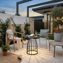 Modern outdoor patio with chairs, table, and plants