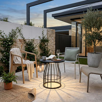 Modern outdoor patio with chairs, table, and plants