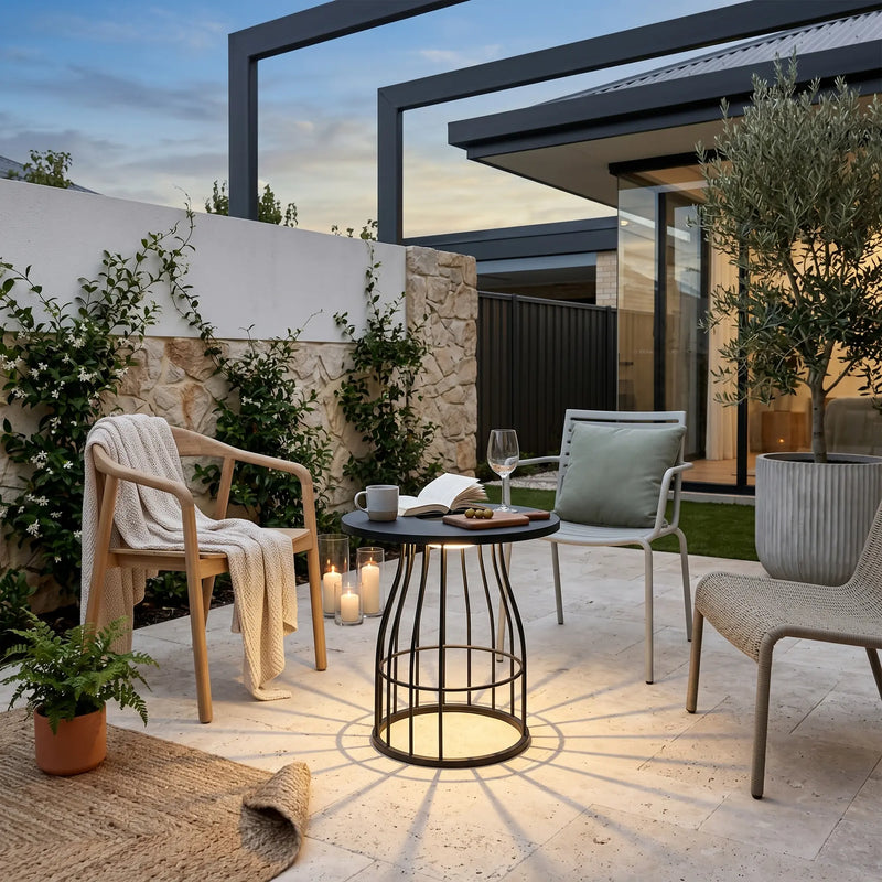 Modern outdoor patio with chairs, table, and plants