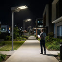 T008 Smart Solar Street Light illuminating a modern residential walkway at night, featuring uniform lighting and ALS 2.4 constant brightness technology.