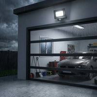 Outway motion sensor with IP65 rating illuminating garage under heavy rain