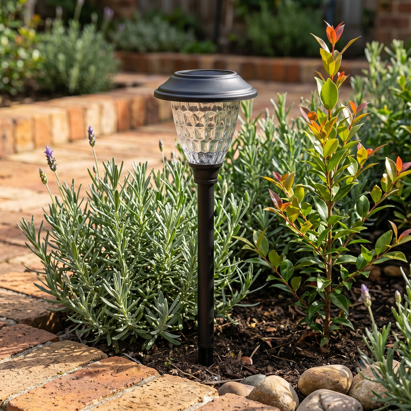 Close-up of solar pathway light with textured crystal glass lens nestled among lavender and rosemary, highlighting its elegant design and seamless integration into garden beds — perfect for enhancing floral landscapes with ambient, low-profile illumination.