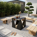 Outdoor patio setting with a black table, wooden benches, and decorative elements.