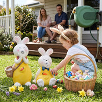 OUTWAY Hoppi A004 solar bubble rabbit standing and sitting ornament pair on a lawn with a toddler in bunny ears collecting Easter eggs beside a wicker basket while parents watch from a deck