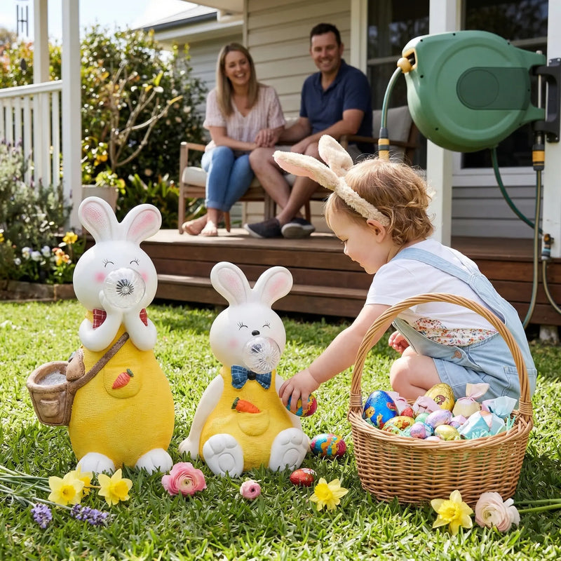 OUTWAY Hoppi A004 solar bubble rabbit standing and sitting ornament pair on a lawn with a toddler in bunny ears collecting Easter eggs beside a wicker basket while parents watch from a deck