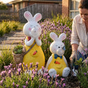 OUTWAY Hoppi A004 solar bubble rabbit standing and sitting ornament pair in a lavender bed with succulents in the basket while a woman gardens alongside in an Australian backyard at golden hour