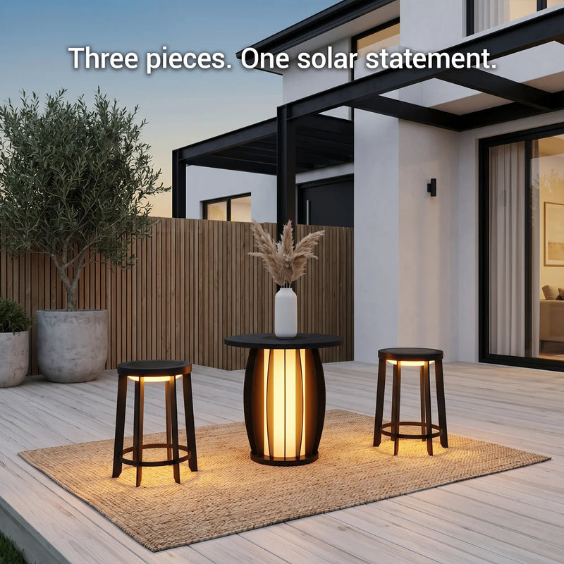 Outdoor setting with a table and two stools on a wooden deck, illuminated by solar lights.