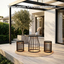 Outdoor patio set with three pieces on a wooden deck, featuring a pergola and plants.