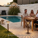 Solar garden lights arranged beside a wooden dining table during an outdoor dinner party, with text overlay “Shadow Art. Every Night. Solar.” and specs “Optical lens. Warm glow. IP65. LiFePO₄. 12H.” — showcasing their role in elevating social gatherings with artistic, long-lasting illumination.