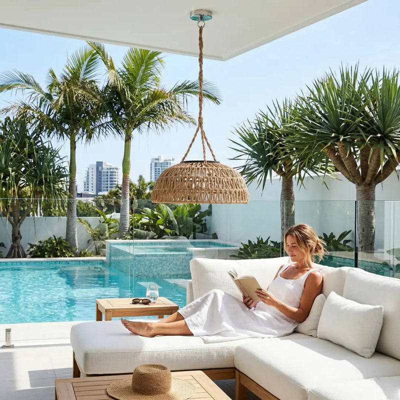 A woman easily swapping the modular solar panel on the top of the PT0901 Kiku Solar Rattan Hanging Lantern, highlighting the user-friendly design.