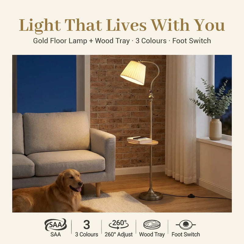 FL068 gold arc floor lamp with wood tray standing in a brick-wall living room at night, warm 3000K glow, feature badges: SAA, 3 colour temps, 260° adjust, wood tray, foot switch