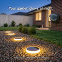 Niteo solar lights glowing on a gravel driveway at dusk, text overlay "Your garden glows all night", showcasing 100% solar powered long-lasting illumination.