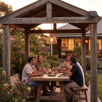 Group of friends laughing around picnic table under PT0913 pendant in wooden gazebo at sunset — perfect for social gatherings with natural texture and adjustable lighting modes.