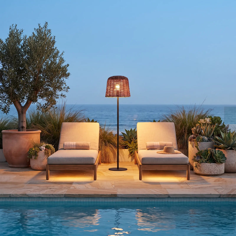 Poolside lounge chairs flanked by solar floor lamp — ocean view enhances luxury feel, showcasing UV-resistant rattan and weighted base stability for coastal or garden use.