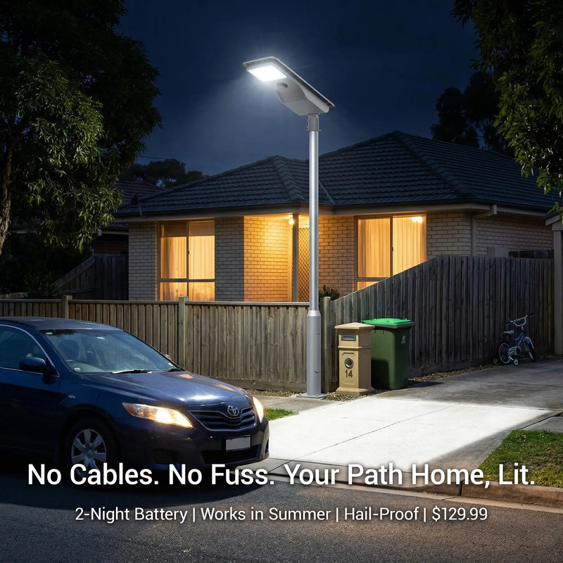 Outway T007ES Nexa solar street light on tall pole lighting a suburban driveway at night with text overlay: "No Cables. No Fuss. Your Path Home, Lit." — 2-night LiFePO4 battery, works in Australian summer, IK07 hail-proof, $129.99.