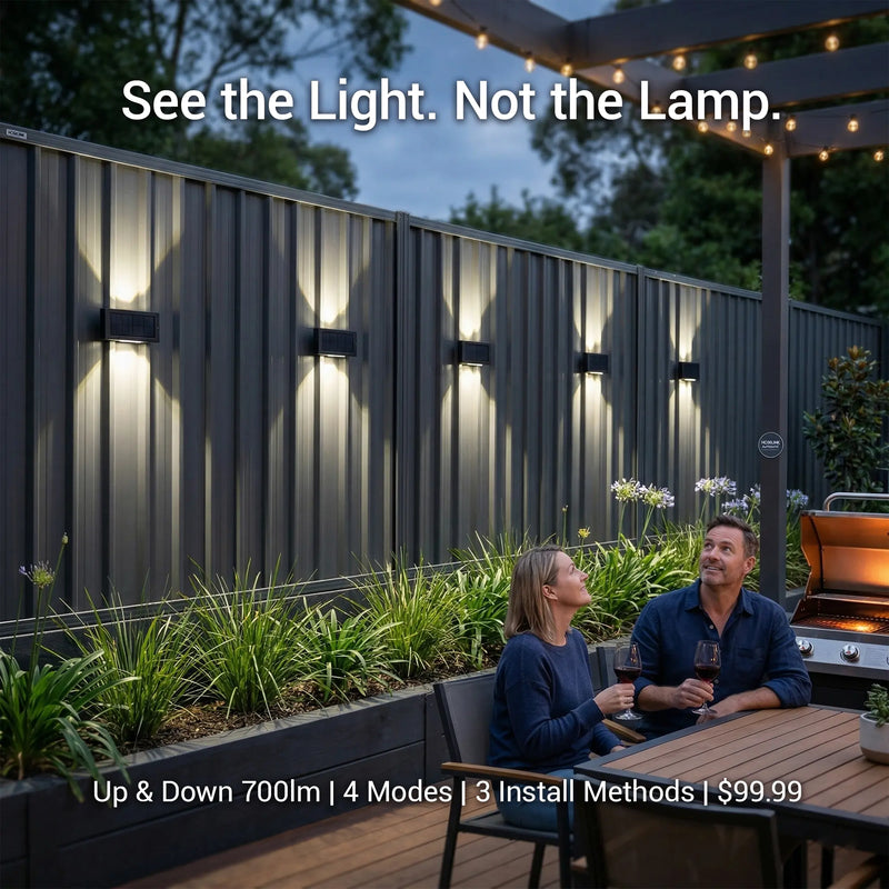Tenox PT0716 solar wall lights illuminating dark fence with dramatic up-down beam, couple relaxing outdoors at night — 700lm, 4 modes, 3 install methods, $99.99