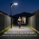 Person walking on a path illuminated by a street light with text about battery life and features.