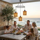 Family dining outdoors by the ocean with sunset view