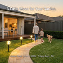 Family walking with a dog on a garden path illuminated by outdoor lights, with text overlay.