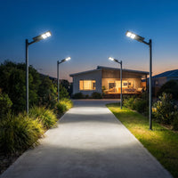Four OUTWAY Nexa T007 solar lights lining a concrete pathway leading to a suburban home, demonstrating wide area coverage.