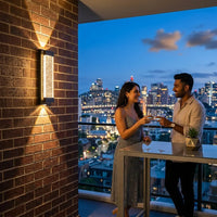Couple enjoying a romantic moment on a balcony with city skyline view at night.