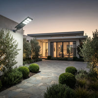 Nexa StreetGlow Pro T007 solar street light illuminating a modern home driveway and garden pathway at dusk.
