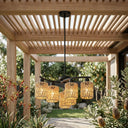 Outdoor ceiling light fixture with rattan-like design hanging from a wooden pergola.