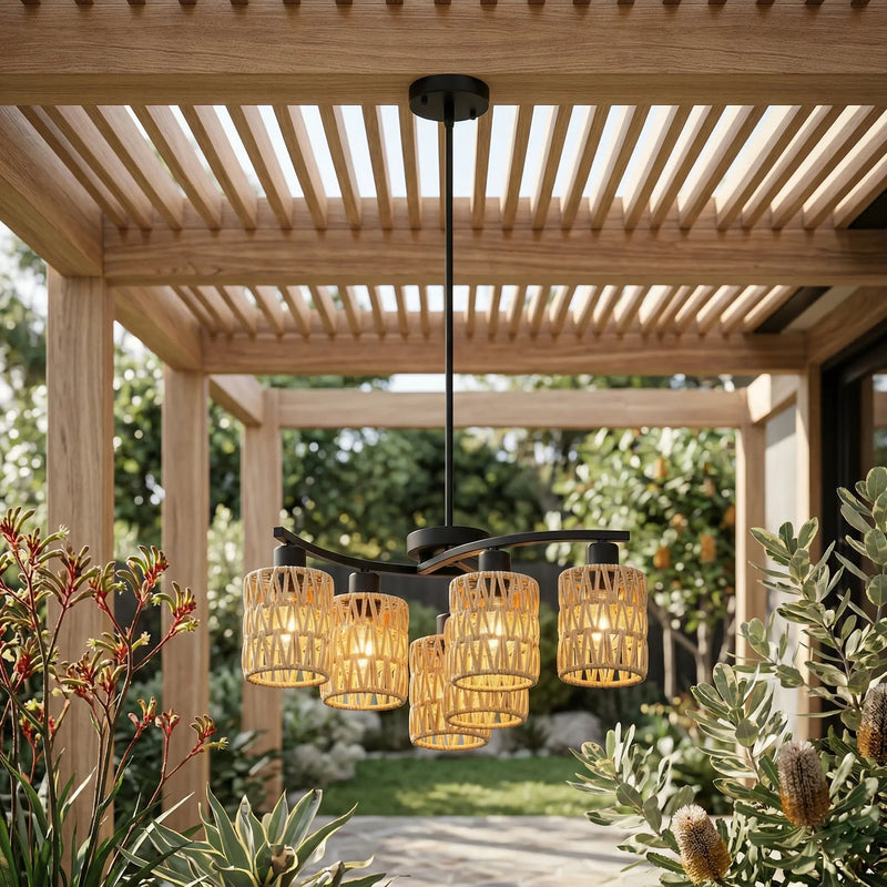 Outdoor ceiling light fixture with rattan-like design hanging from a wooden pergola.