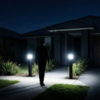 Two PT0730 Virgo solar bollard lights activating at full brightness on Australian suburban driveway entrance at night triggered by motion sensor security mode 6000K cool white