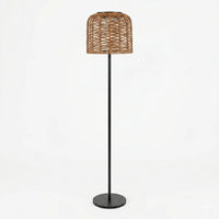 Modern rattan floor lamp with a woven basket shade and sleek black metal stand, featuring a round base.