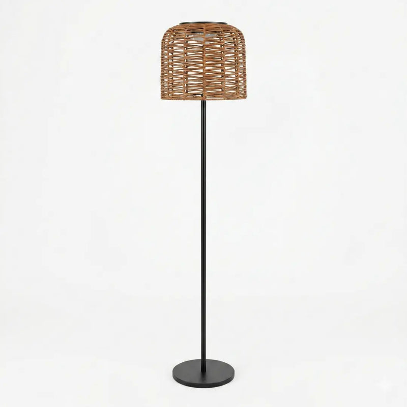 Modern rattan floor lamp with a woven basket shade and sleek black metal stand, featuring a round base.