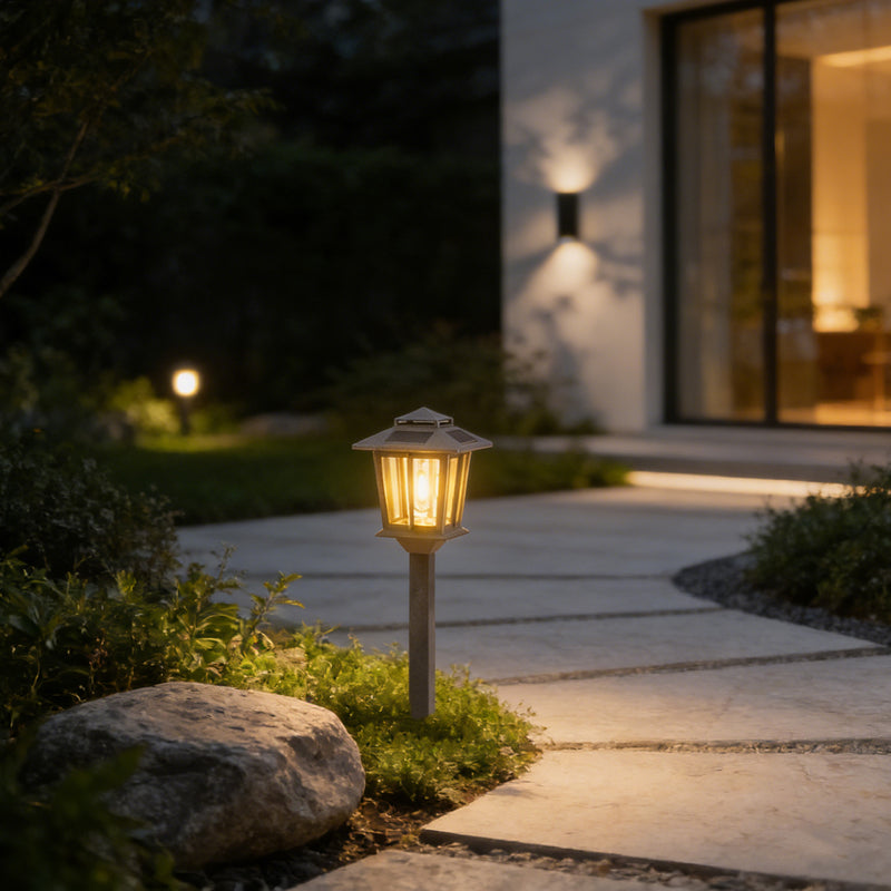 Garden path with a solar lamp and modern house in the background
