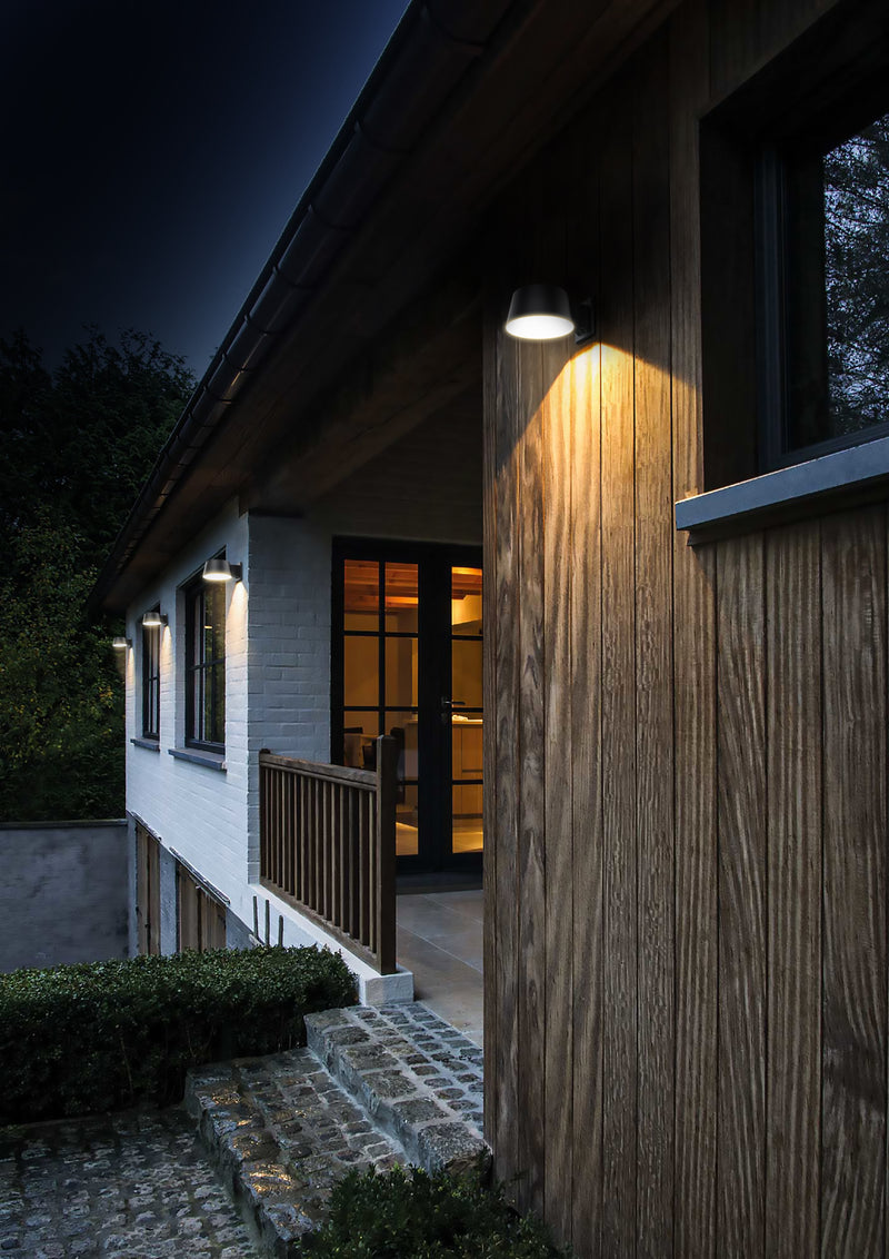Modern house exterior with wooden facade and outdoor lighting