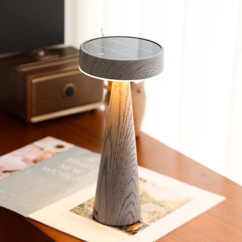 Wooden table lamp with solar panel on a wooden surface