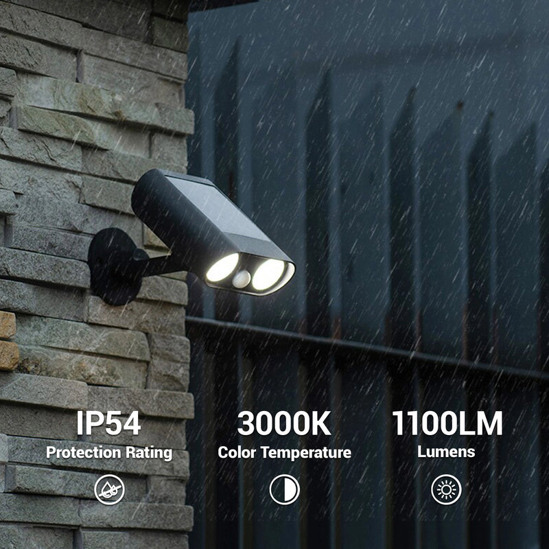 Outdoor solar spotlight mounted on a stone wall with rain protection features displayed.