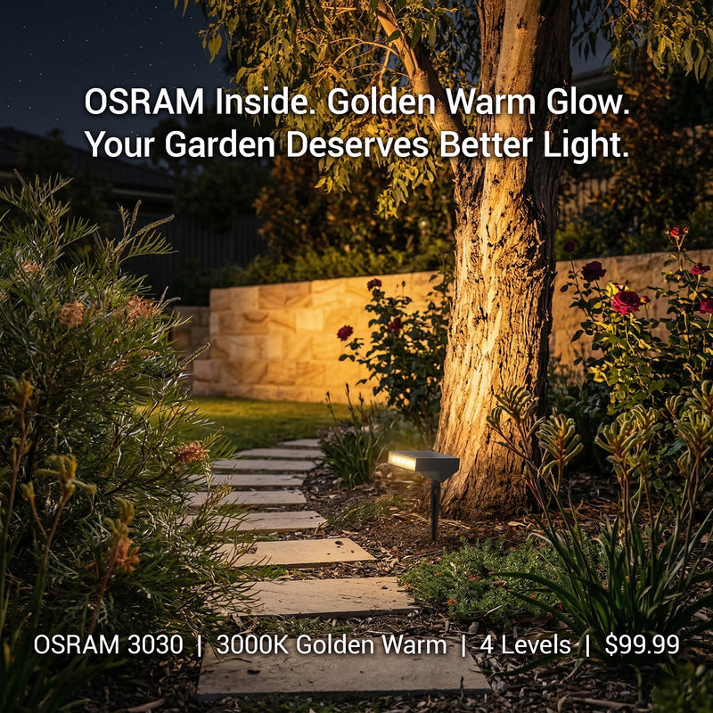 Garden pathway illuminated by a light fixture with OSRAM branding.