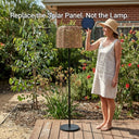 A woman holding a replaceable solar panel in a garden, demonstrating the PT0908 Floor Lamp's modular design and emphasizing the sustainable concept of 'Replace the Solar Panel. Not the Lamp.' alongside its 148cm woven body.