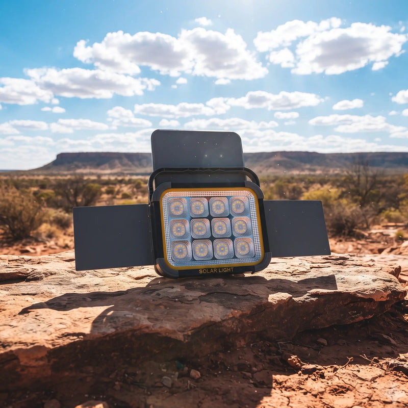 SolarFlex Pro unfolds four panels on rock in desert; “SOLAR LIGHT” label visible, showcasing portable solar charging design.
