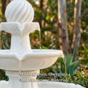 Close-up of OUTWAY solar garden fountain upper tier showing water cascading from swirl ball topper through leaf-detail spouts made of resin fiberglass and sandstone material with text overlay