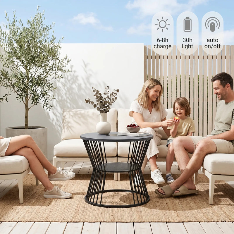 Family sitting on outdoor furniture set with a table, enjoying a sunny day.