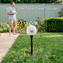 Garden light fixture with text 'Where's the Solar Panel? Inside.' in a garden setting.