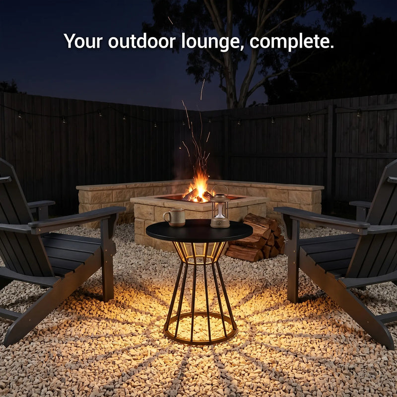 Outdoor lounge setup with fire pit, chairs, and table at night.