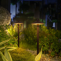 A garden path illuminated by a solar mushroom pathway light, creating a warm and inviting atmosphere.